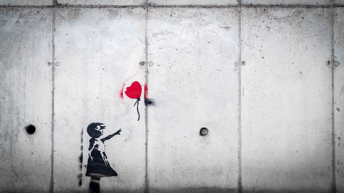 Stencil art of a girl letting go of a heart-shaped balloon