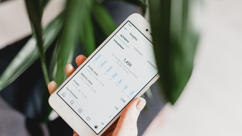 A smartphone showing insights statistics for a social media account