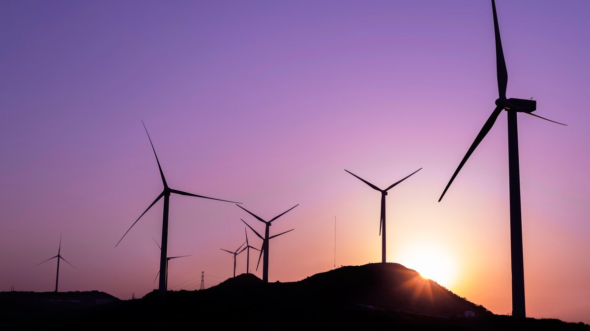 Wind turbines against a sunset
