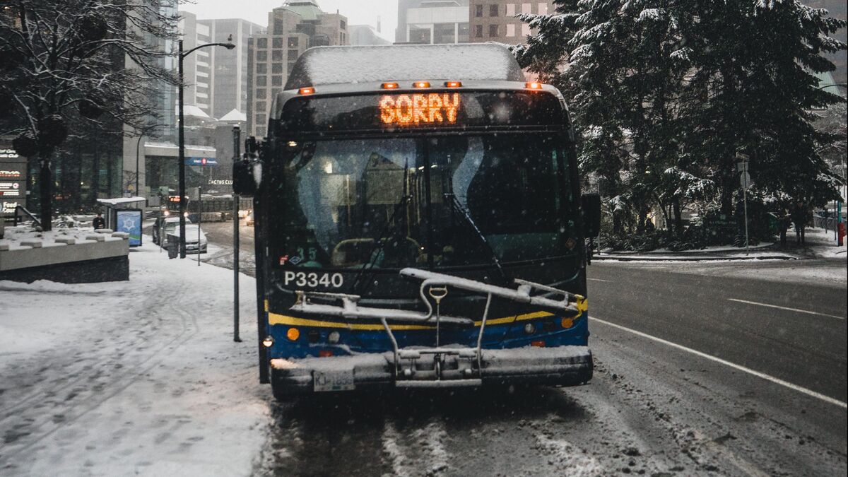 Bus with "Sorry" sign, stopped on snowy road