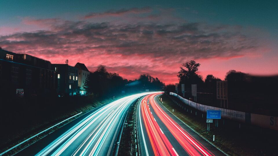 Streaks of light from cars on a road at dusk