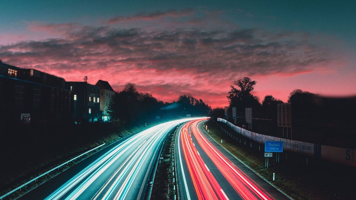 Streaks of light from cars on a road at dusk