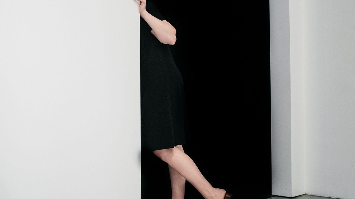 Person looking behind a doorway