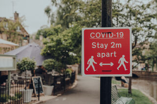 Street sign: Covid-19: Stay 2m apart