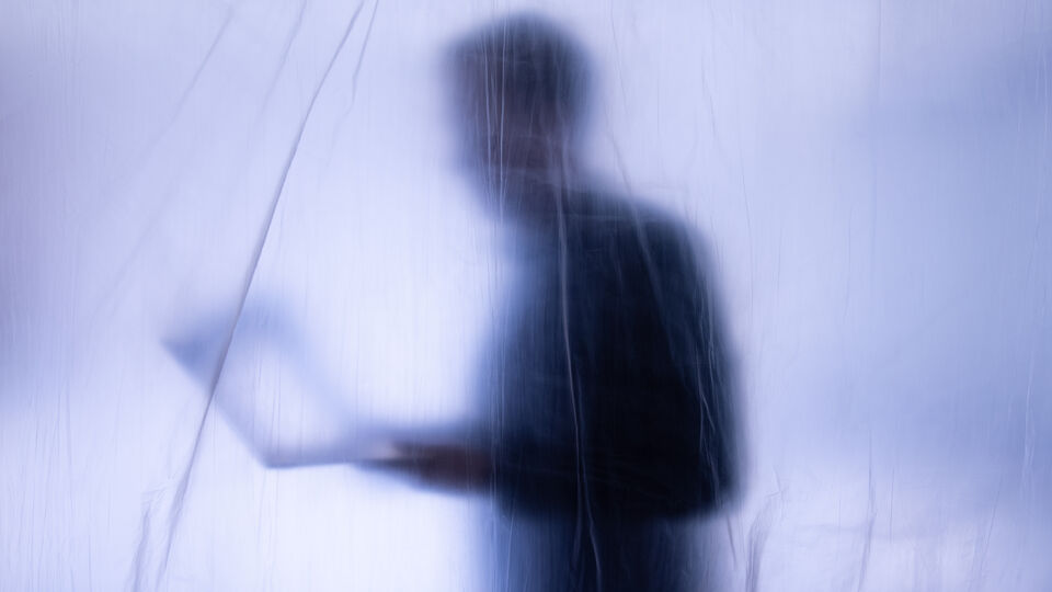 Person obscured by a translucent sheet