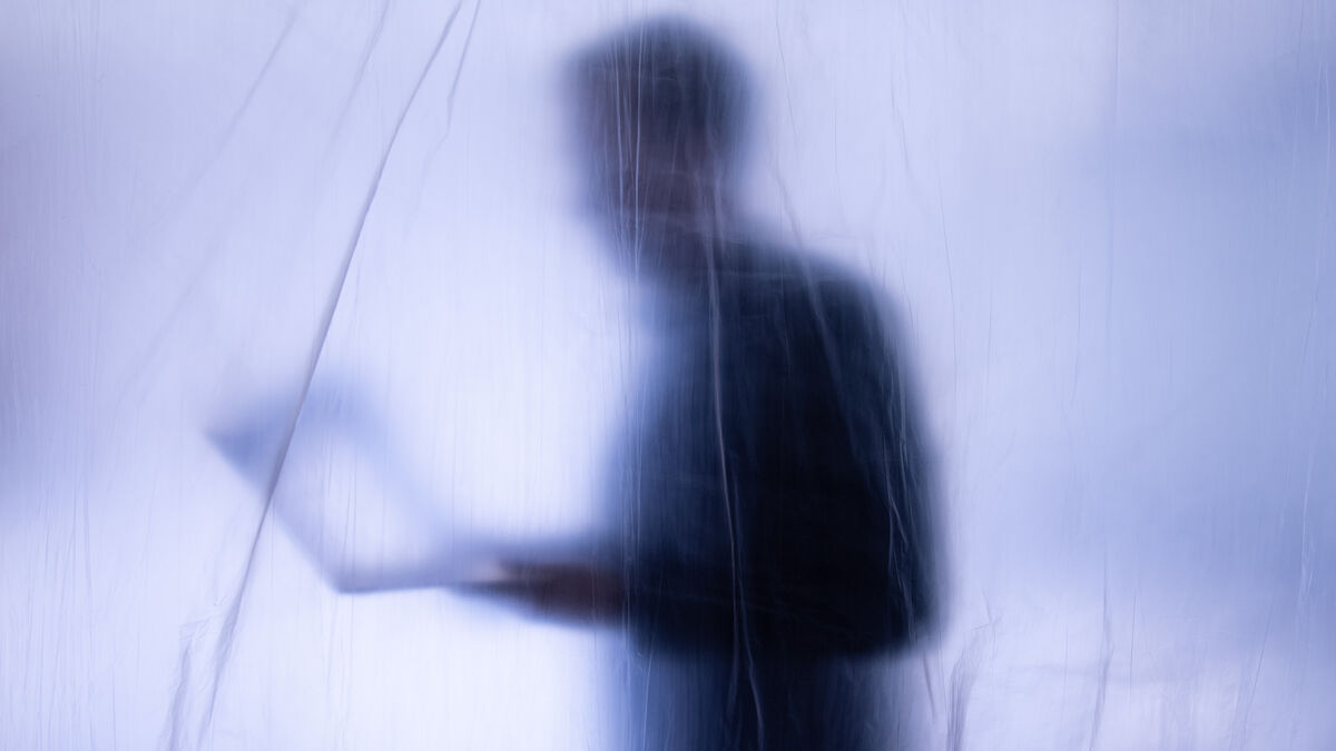 Person obscured by a translucent sheet